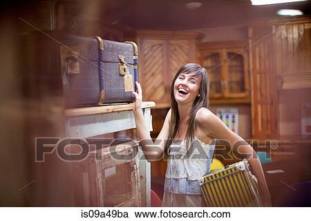 Woman shopping in thrift store View Large Photo Image Stock Image - Woman shopping in thrift store. Fotosearch