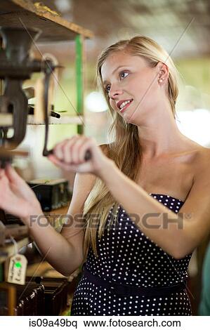 Woman shopping in thrift store View Large Photo Image Stock Photography - Woman shopping in thrift store. Fotosearch