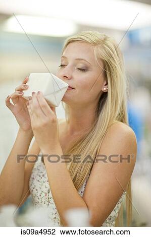 Woman smelling candle in store View Large Photo Image Stock Image - Woman smelling candle in store. Fotosearch