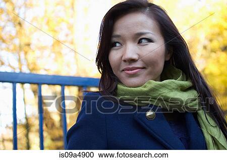Stock Image - Woman standing outdoors. Fotosearch