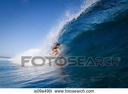 Woman surfing in crest of wave View Large Photo Image Stock Image - Woman surfing in crest of wave. Fotosearch