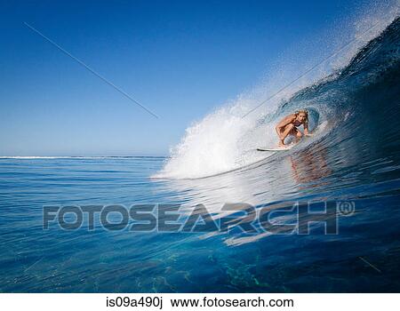 Woman surfing in crest of wave View Large Photo Image Stock Image - Woman surfing in crest of wave. Fotosearch