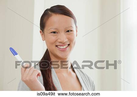 Woman taking pregnancy test in bathroom View Large Photo Image Stock Photograph - Woman taking pregnancy test in bathroom. Fotosearch