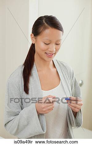 Woman taking pregnancy test in bathroom View Large Photo Image Stock Photography - Woman taking pregnancy test in bathroom. Fotosearch