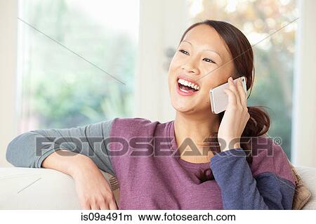 Picture - Woman talking on cell phone. Fotosearch