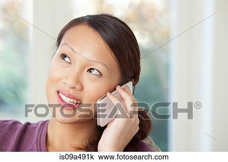 Stock Image - Woman talking on cell phone. Fotosearch