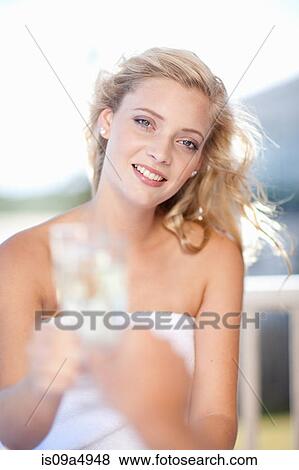 Stock Photo - Woman toasting with wine outdoors. Fotosearch