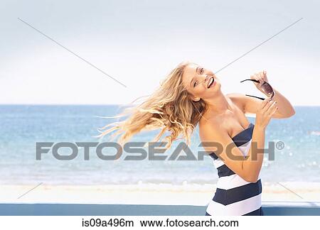 Woman tossing her hair on beach View Large Photo Image Picture - Woman tossing her hair on beach. Fotosearch