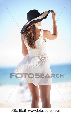 Stock Photography - Woman walking on beach. Fotosearch
