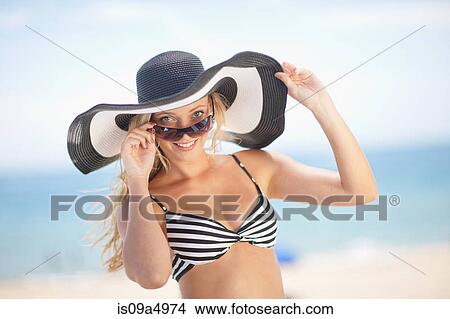 Woman wearing bikini and floppy hat View Large Photo Image Picture - Woman wearing bikini and floppy hat. Fotosearch