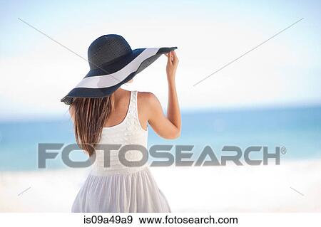 Woman wearing floppy hat on beach View Large Photo Image Stock Photo - Woman wearing floppy hat on beach. Fotosearch