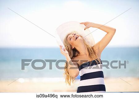 Woman wearing floppy hat on beach View Large Photo Image Stock Photography - Woman wearing floppy hat on beach. Fotosearch
