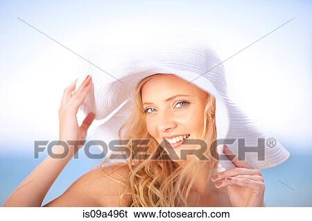 Stock Photograph - Woman wearing floppy hat outdoors. Fotosearch