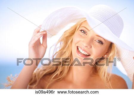 Stock Photography - Woman wearing floppy hat outdoors. Fotosearch