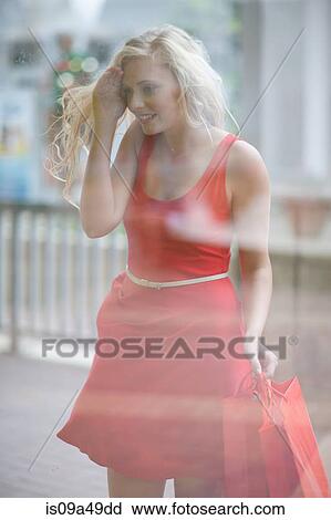 Stock Image - Woman window shopping on street. Fotosearch