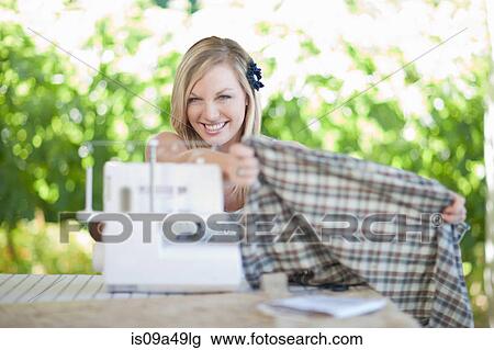 Woman working on sewing machine View Large Photo Image Stock Image - Woman working on sewing machine. Fotosearch