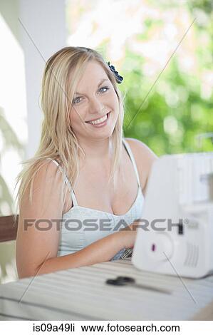 Woman working on sewing machine View Large Photo Image Stock Image - Woman working on sewing machine. Fotosearch