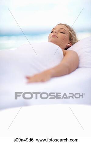 Stock Photograph - Woman wrapped in blanket outdoors. Fotosearch