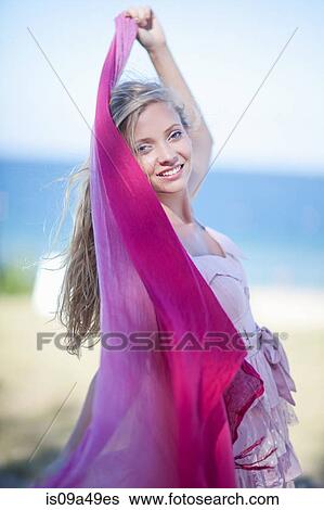 Stock Photograph - Woman wrapped in scarf outdoors. Fotosearch