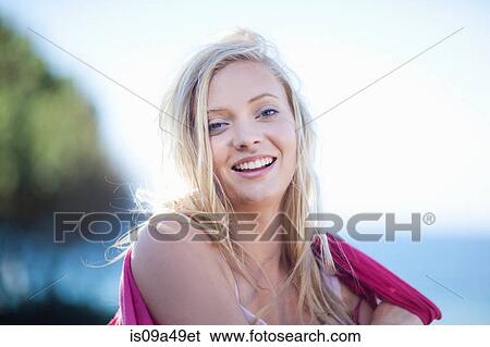 Stock Photograph - Woman wrapped in scarf outdoors. Fotosearch