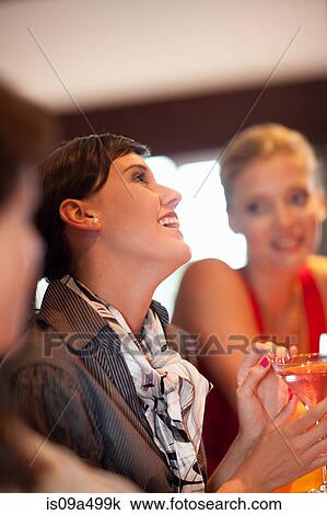 Women having drinks together at bar View Large Photo Image Stock Image - Women having drinks together at bar. Fotosearch