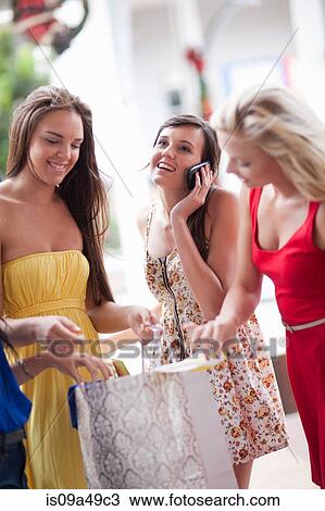 Women looking in shopping bag View Large Photo Image Stock Image - Women looking in shopping bag. Fotosearch