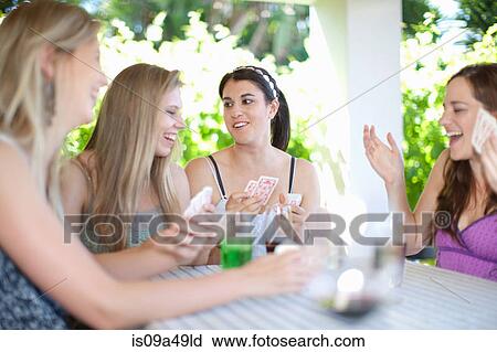 Stock Image - Women playing cards at table. Fotosearch