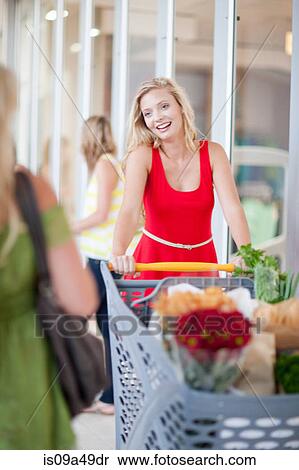 Women pushing shopping cart View Large Photo Image Stock Photography - Women pushing shopping cart. Fotosearch