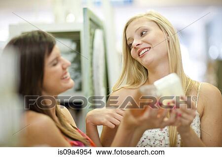 Picture - Women shopping for candles in store. Fotosearch