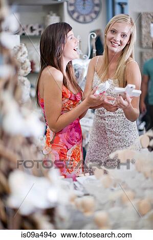 Women shopping together in store View Large Photo Image Picture - Women shopping together in store. Fotosearch