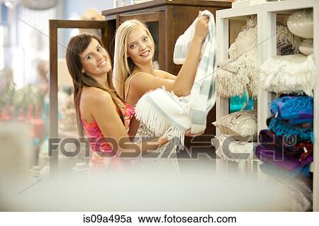 Stock Image - Women shopping together in store. Fotosearch