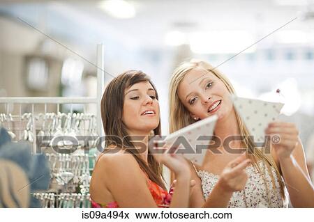 Women shopping together in store View Large Photo Image Stock Photo - Women shopping together in store. Fotosearch