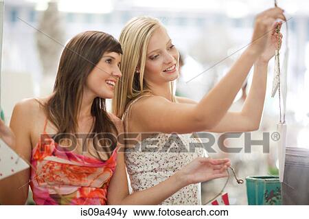 Women shopping together in store View Large Photo Image Stock Photo - Women shopping together in store. Fotosearch