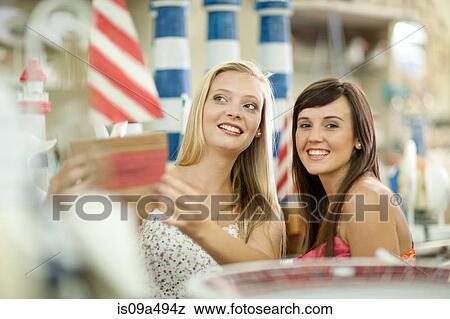 Women shopping together in store View Large Photo Image Stock Photo - Women shopping together in store. Fotosearch