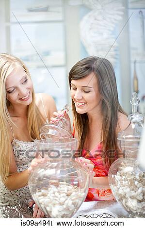 Stock Photograph - Women shopping together in store. Fotosearch