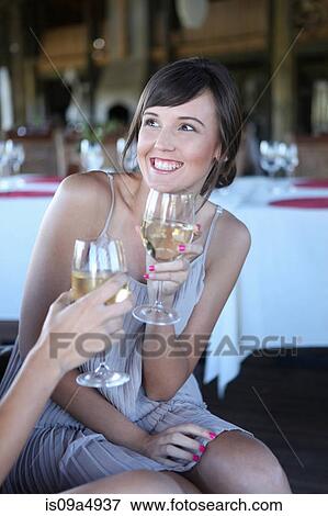 Women toasting each other with wine View Large Photo Image Stock Photo - Women toasting each other with wine. Fotosearch