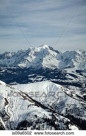 Stock Image - Aerial view of snowy mountains. Fotosearch