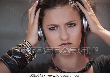 Angry teenage girl wearing headphones View Large Photo Image Stock Photo - Angry teenage girl wearing headphones. Fotosearch