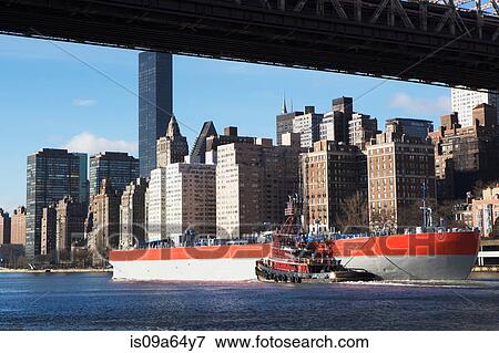 Stock Photo - Barge under New York City bridge. Fotosearch