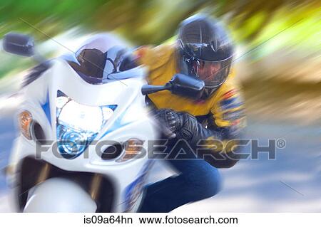 Blurred view of man riding motorcycle View Large Photo Image Picture - Blurred view of man riding motorcycle. Fotosearch