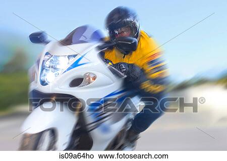 Blurred view of man riding motorcycle View Large Photo Image Picture - Blurred view of man riding motorcycle. Fotosearch