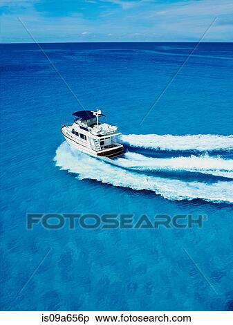 Stock Photography - Boat sailing in tropical water. Fotosearch
