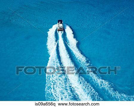 Boat sailing in tropical water View Large Photo Image Stock Photography - Boat sailing in tropical water. Fotosearch