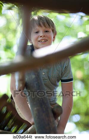 Boy climbing jungle gym outdoors View Large Photo Image Stock Photograph - Boy climbing jungle gym outdoors. Fotosearch