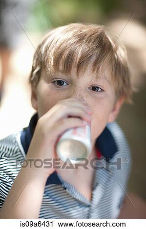 Boy drinking soda outdoors View Large Photo Image Stock Image - Boy drinking soda outdoors. Fotosearch