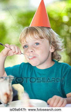 Boy having ice cream sundae at party View Large Photo Image Stock Image - Boy having ice cream sundae at party. Fotosearch