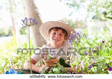 Boy potting plants outdoors View Large Photo Image Stock Photo - Boy potting plants outdoors. Fotosearch