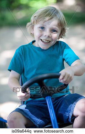 Boy riding go-kart outdoors View Large Photo Image Stock Photography - Boy riding go-kart outdoors. Fotosearch