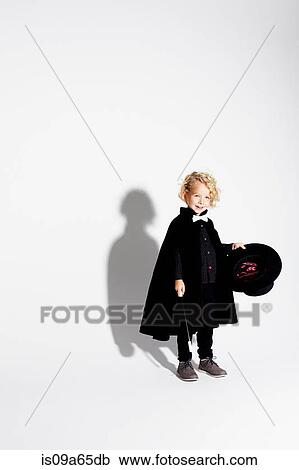 Stock Image - Boy wearing magician costume. Fotosearch