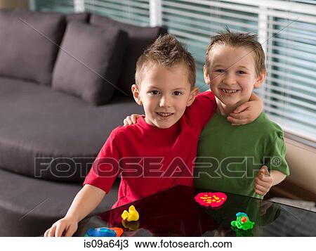 Boys playing with toys on counter View Large Photo Image Stock Image - Boys playing with toys on counter. Fotosearch